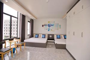 a hospital room with two beds and a table at King House Hotel in Móng Cái +14 photos