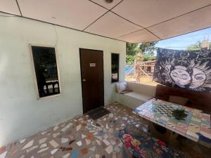 a living room with a couch and a window at Karaked House in Chaloklum