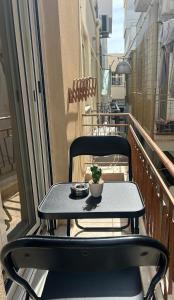 a table on a balcony with a plant on it at MINAS CENTRAL apartments in Heraklio