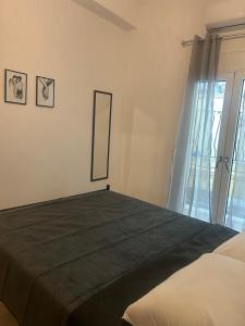 a bedroom with a bed with a mirror and a window at MINAS CENTRAL apartments in Heraklio