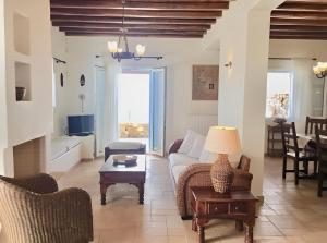a living room with a couch and a table at Mykonos Dot - The Villas in Mikonos
