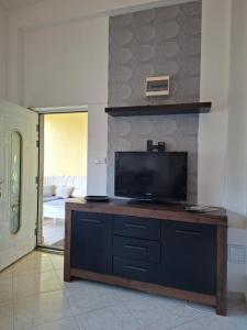 a living room with a flat screen tv on a table at Siófok 7 Apartmanház in Siófok