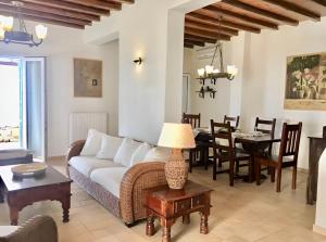 a living room with a couch and a table at Mykonos Dot - The Villas in Mikonos