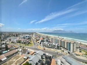 an aerial view of a city and the ocean at Relaxing Blouberg Beachfront view Apartment in Cape Town