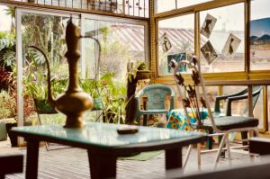 a room with a table and chairs and a window at Le Karthala in Antananarivo +23 photos