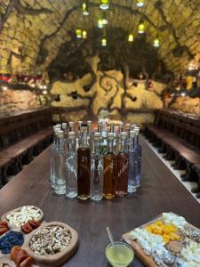a table with several bottles of alcohol and other food at Hanul lui Hanganu in Lalova