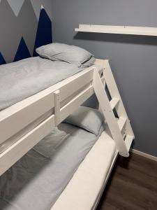 a white bunk bed in a room at Modern apartment - Balcony, Parking, BBQ in Vossevangen +15 photos