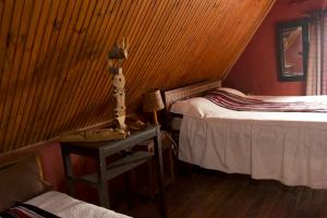 a bedroom with two beds and a table with a lamp at Le Karthala in Antananarivo