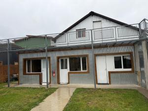 a house with a balcony on top of it at Nomade Aparts in El Chalten
