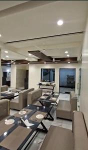 a room with chairs and tables in a room at The Nature Park Hotel in Mudhol