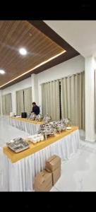 a room with a long table with food on it at The Nature Park Hotel in Mudhol