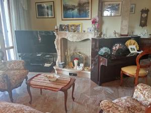 a living room with a fireplace and a piano at B&B Villa Adriano in Cavaion Veronese