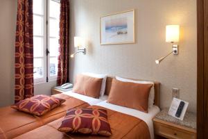 a hotel room with two beds with pillows at Hôtel la Croix Blanche in Le Mont Saint Michel