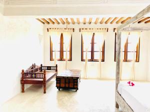a living room with two benches and a table at Kilele-Retreat Suite in Shela