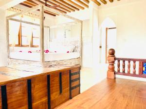a large bathroom with a tub and a large mirror at Kilele-Retreat Suite in Shela