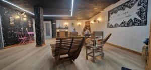a room with two chairs and a table in a room at Lucà Apartments in Saluzzo