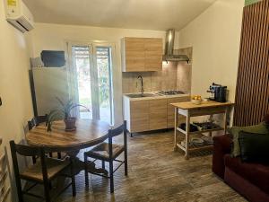 a kitchen with a wooden table and a dining room at Podere Al Covo - House, Garden & Vineyard - Alghero in Alghero