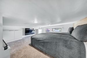 a bedroom with a large bed and a flat screen tv at The Riv at Zion in Virgin