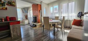 a kitchen and living room with a table and chairs at Апартамент При Рени in Koprivshtitsa