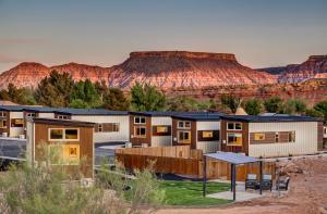 a row of modular homes in the desert with mountains at The Riv at Zion in Virgin