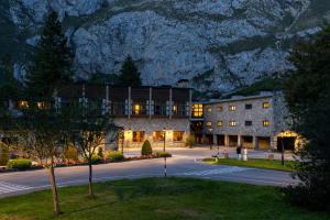 a building in front of a mountain at night at Parador de Fuente Dé in Fuente Dé