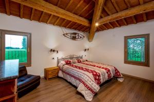 a bedroom with a bed and a couch and windows at Agriturismo Ferrara Chalet in Vigarano Mainarda