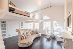 a living room with a couch and a table at Loft City View in Budapest