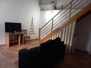 a living room with a couch and a staircase at Casa da Ti Joana in Aranhas