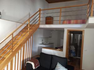 a living room with a staircase and a couch at Casa da Ti Joana in Aranhas