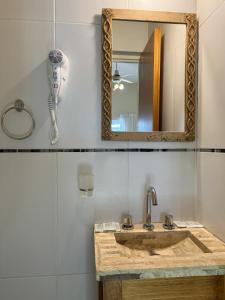 a bathroom with a sink and a mirror at Hotel Europa in Buenos Aires +35 photos
