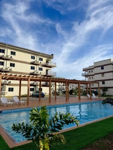 a swimming pool in front of a building at The Gatehouse Tobago in Buccoo