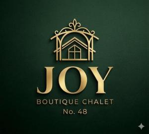 a gold logo for joy boutique chatelaine at JOY Boutique Chalet Berkhout - Hoorn in De Hulk