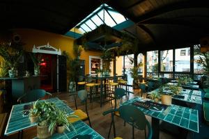 a restaurant with tables and chairs and windows at Ambra Cortina Luxury&Fashion Hotel in Cortina dʼAmpezzo