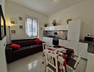 a living room with a couch and a table at ViaGiotto Guest House in Certaldo