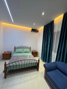 a bedroom with a bed and a couch at Azure Horizon in Çukë +2 photos