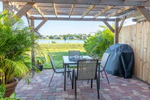 a patio with a table and chairs under a pergola at Lake Marlin Villa 2 in Port Charlotte