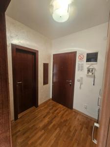 an empty room with two doors and wooden floors at MakiLen in Vrnjačka Banja +8 photos