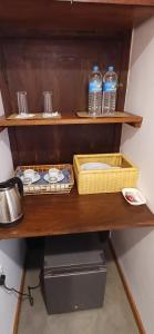 a shelf with two bottles of water and a printer at Elite Nest in Ahangama