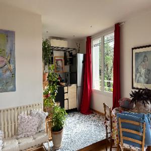 a living room with a couch and a window at À l'ombre du mûrier in Blauvac