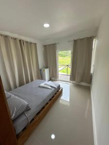 a bedroom with a bed with curtains and a window at Villa Rio Grande in Santa Catalina