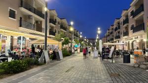 a street at night with people walking down the street at Casa Anna - Velapi - Los Alcázares in San Javier