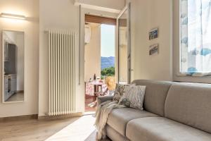 a living room with a couch and a table at Giò Apartment on the beach front - mytouristhome in Portovenere