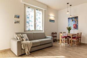 a living room with a couch and a table at Giò Apartment on the beach front - mytouristhome in Portovenere