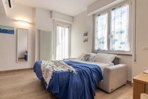 a bedroom with a bed and a large window at Giò Apartment on the beach front - mytouristhome in Portovenere
