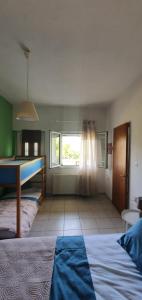 a room with a bed and a pool table in it at Karouti-Rooms for Rent in Pteleos +2 photos