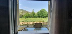 a room with a window with a tub and a view at Karouti-Rooms for Rent in Pteleos