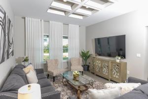 a living room with a couch and a table at Lake Marlin Villa 2 in Port Charlotte