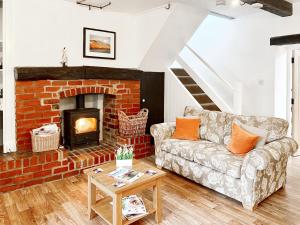a living room with a couch and a fireplace at Brook House 2 - Uk31043 in Bassenthwaite