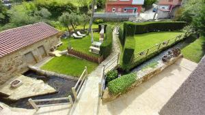 an aerial view of a house with a garden at O Relax do Río - Casa Molino Boutique, con Jardín y Desayuno en Muxía in Muxia