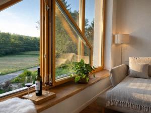 a window with a bottle of wine and two glasses at Hiša PRI JEZERU in Dobrovnik